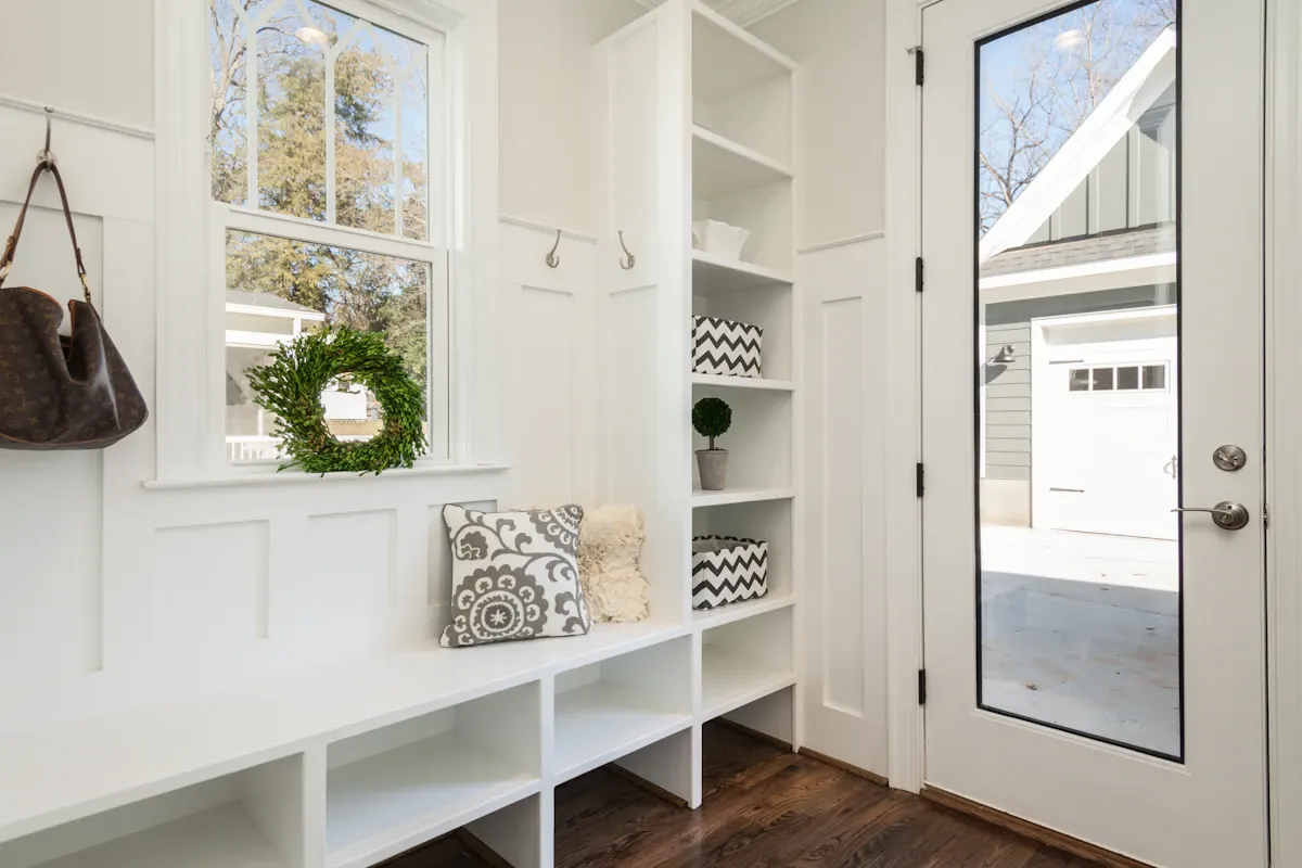 Entryway with a fitted bench, cupboards and open cubbies