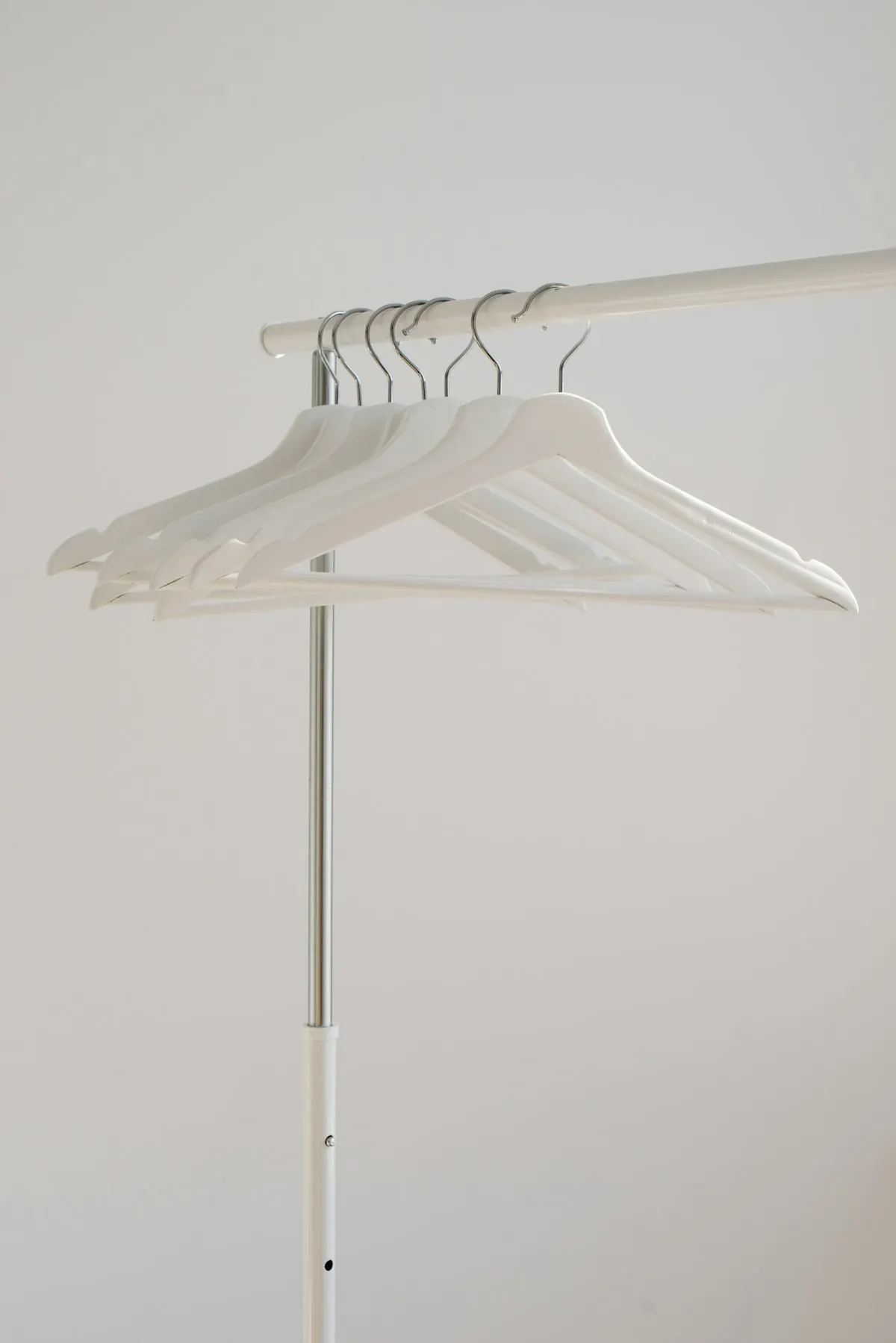 Simple white clothes rack with empty hangers
